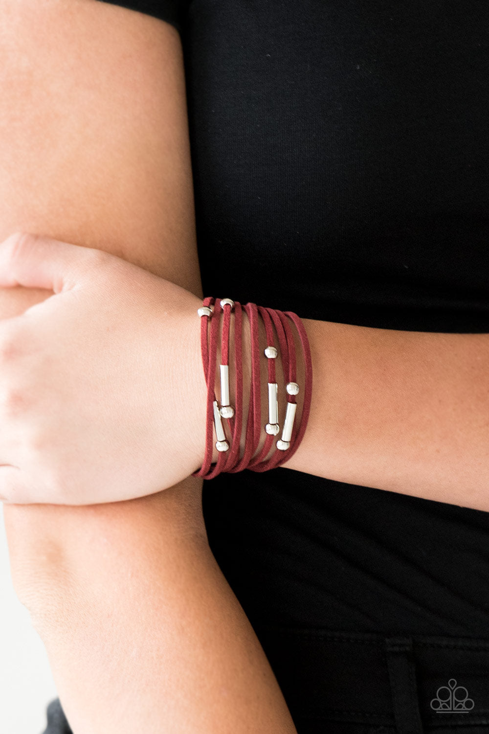 Paparazzi Accessories Red Bracelet with leatherlike strands. Sliver charms scattered throughout the bracelet
