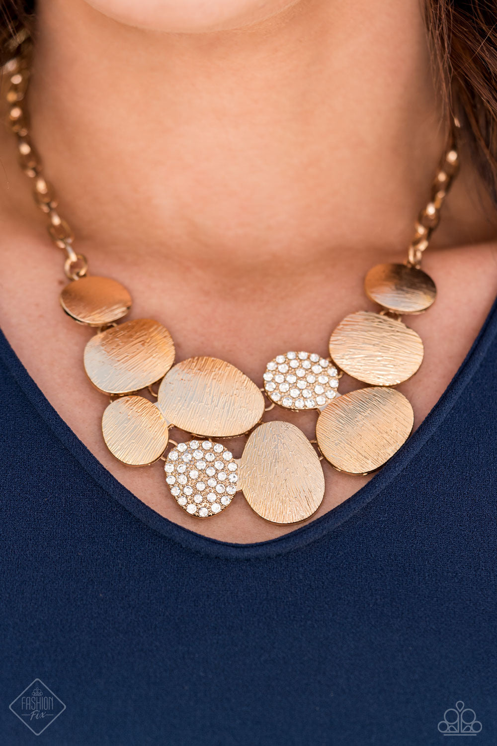 Gold necklace featuring a collection of asymmetrical oval discs connect into a clustered pendant below the collar for a refined flair.
