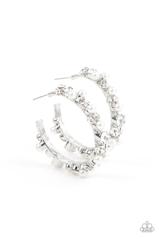 Life of the Party - A bubbly array of classic white rhinestones and glassy white rhinestones are encrusted along the front of a silver hoop, creating an elegantly effervescent look. Earring attaches to a standard post fitting. Hoop measures approximately 1 1/2" in diameter. All Paparazzi accessories are nickel free and lead free.