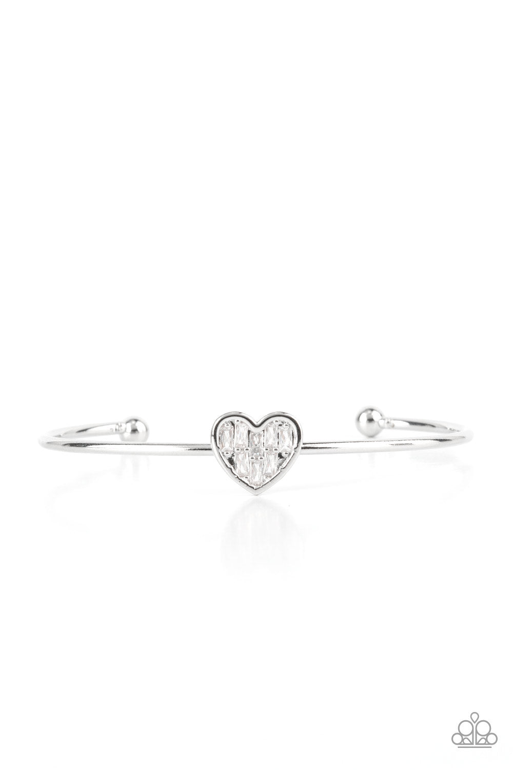 Brimming with dainty emerald-cut white rhinestones, a simple silver heart frame sits atop a classic silver bar curved into a simple cuff bracelet for a whimsical display across the wrist.