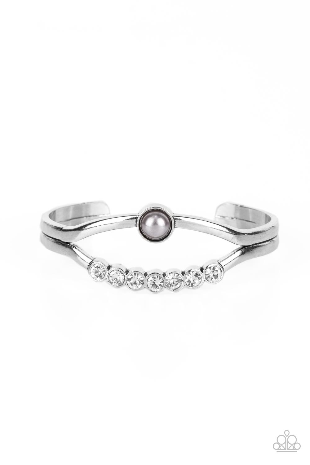 A row of white rhinestones and a solitaire silver pearl adorn the layered center of a classic silver cuff, creating a timeless piece around the wrist.