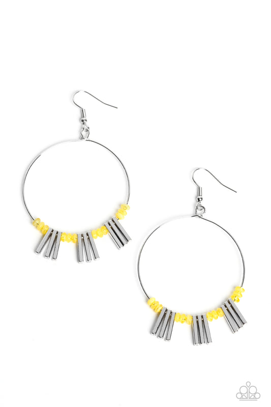 Tiny primrose beads are threaded along the bottom edge of a skinny silver hoop. The beads are separated by sections of rectangular silver bars that accentuate the curvature of the hoop, resulting in a flared design that demands attention.