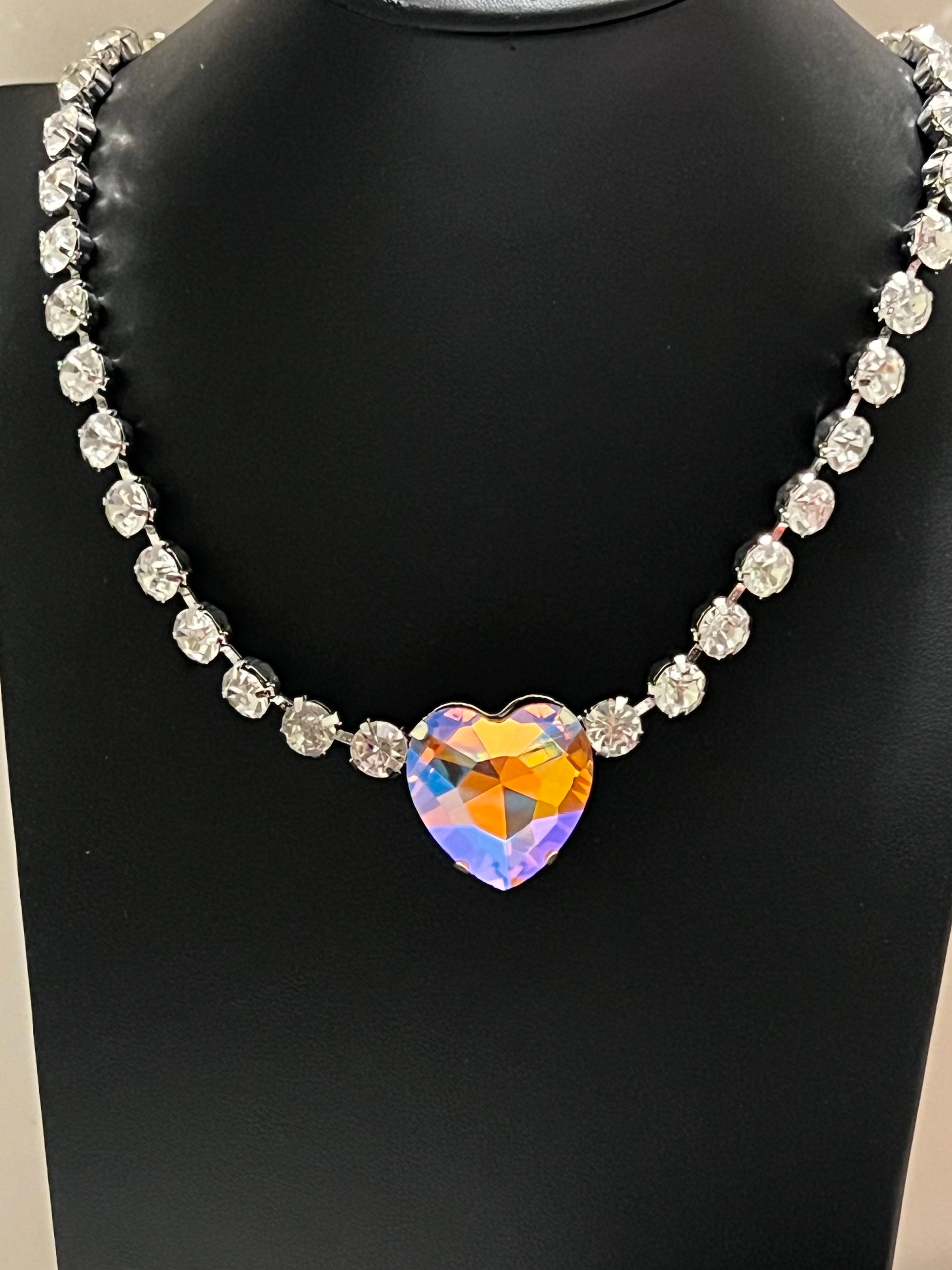 Paparazzi Accessories - Heart in my throat is a beautiful design of iridescent rhinestone with hits of orange and white bling. You are going to love it!